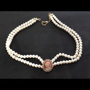 Faux Pearl necklace with silhouette figure head and rhinestones